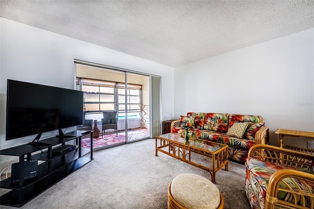 5197 Silent Loop, Unit 224 New Port Richey, FL 34652 - Photo 16 of 41 a living room with furniture and a flat screen tv