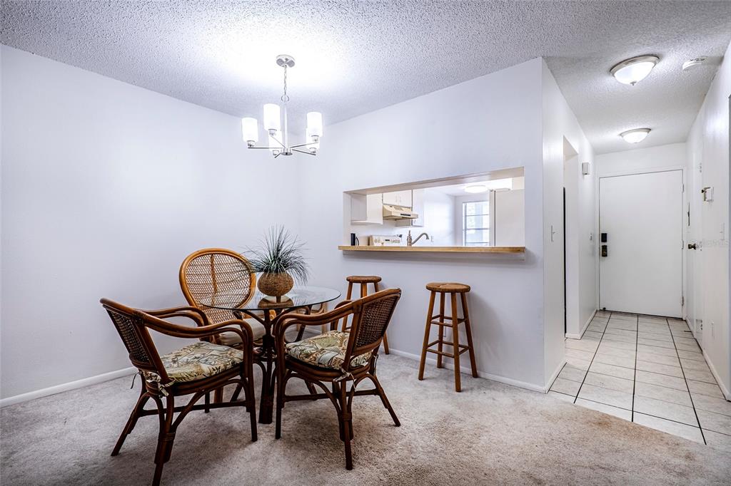 5197 Silent Loop, Unit 224 New Port Richey, FL 34652 - Photo 20 of 41 a view of a dining room with furniture and chandelier