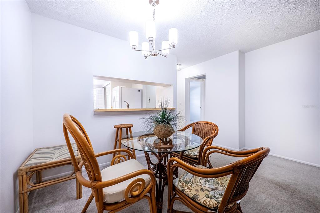5197 Silent Loop, Unit 224 New Port Richey, FL 34652 - Photo 21 of 41 a dining room with furniture and chandelier