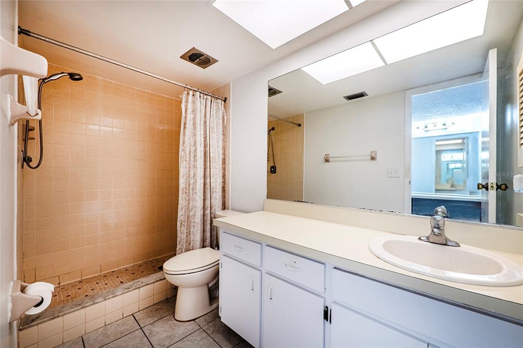5197 Silent Loop, Unit 224 New Port Richey, FL 34652 - Photo 27 of 41 a bathroom with a sink a toilet and shower