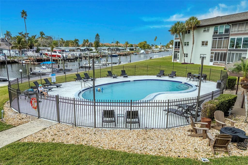 5197 Silent Loop, Unit 224 New Port Richey, FL 34652 - Photo 38 of 41 a view of a swimming pool with a lounge chairs