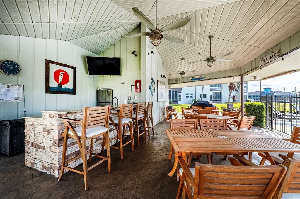 5197 Silent Loop, Unit 224 New Port Richey, FL 34652 - Photo 39 of 41 a dining room with furniture and a flat screen tv