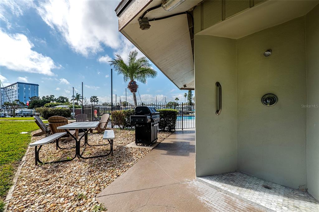 5197 Silent Loop, Unit 224 New Port Richey, FL 34652 - Photo 40 of 41 a view of a patio with table and chairs couches fire pit and barbeque grill