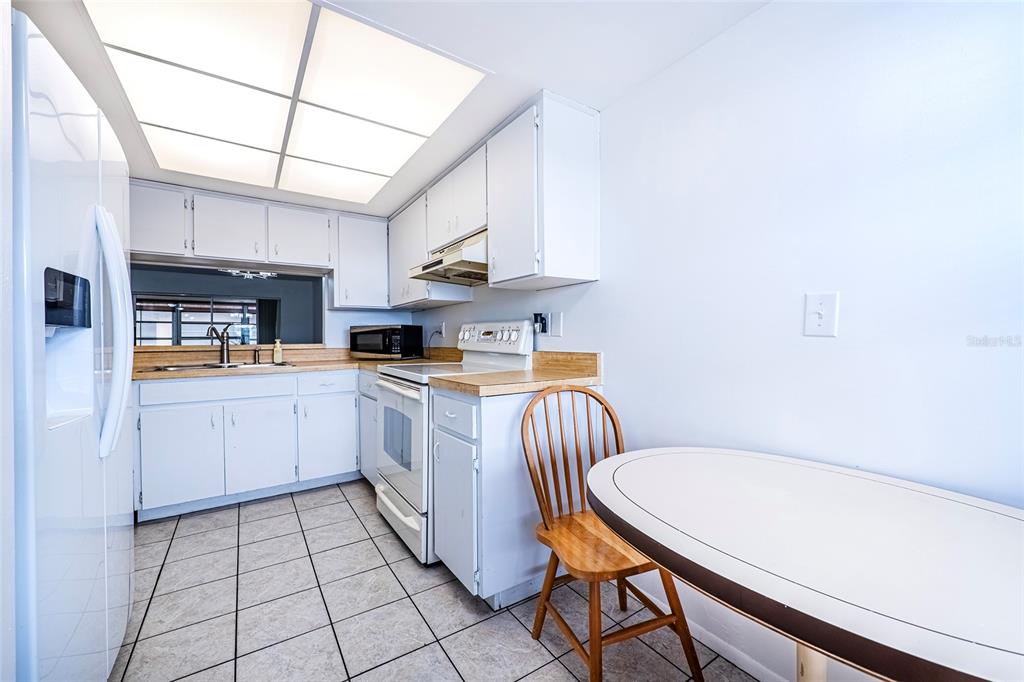5197 Silent Loop, Unit 224 New Port Richey, FL 34652 - Photo 8 of 41 a kitchen with a sink appliances and cabinets