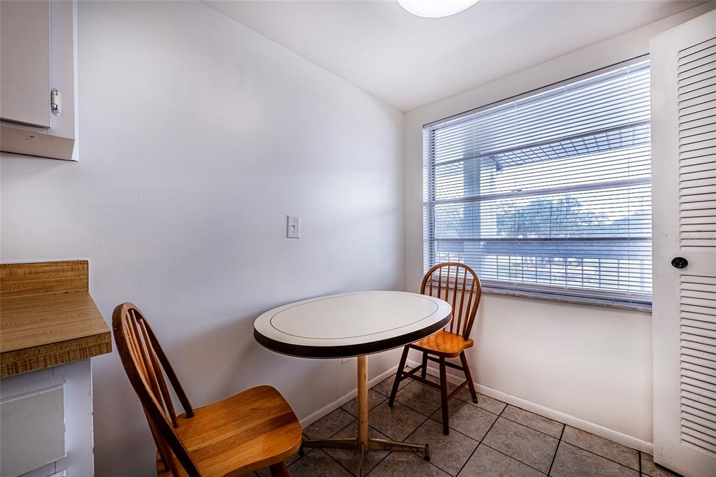 5197 Silent Loop, Unit 224 New Port Richey, FL 34652 - Photo 9 of 41 a chair and a table in a kitchen