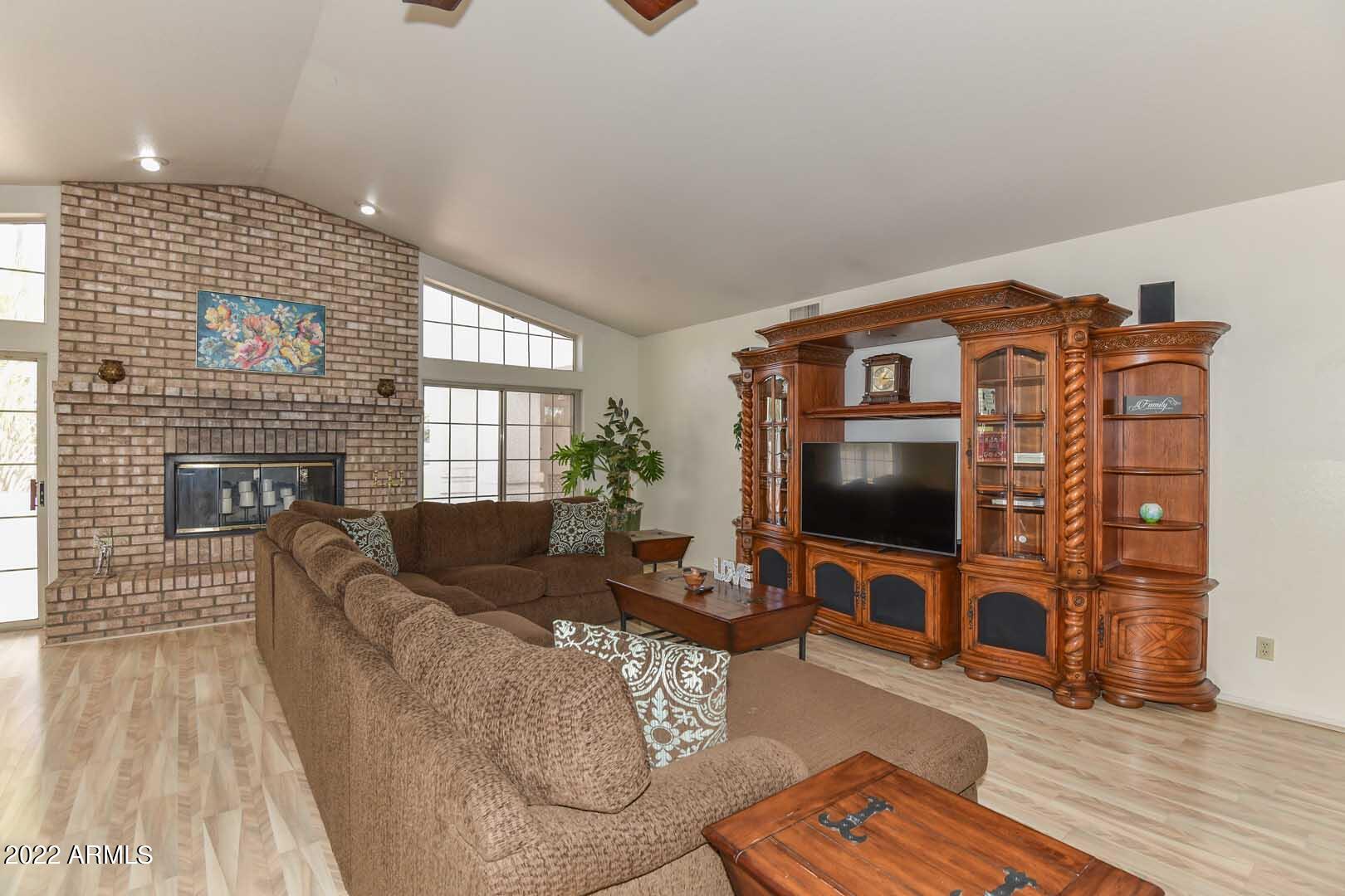 5237 North 106th Avenue Glendale, AZ 85307 - Photo 14 of 75 a living room with furniture and a flat screen tv