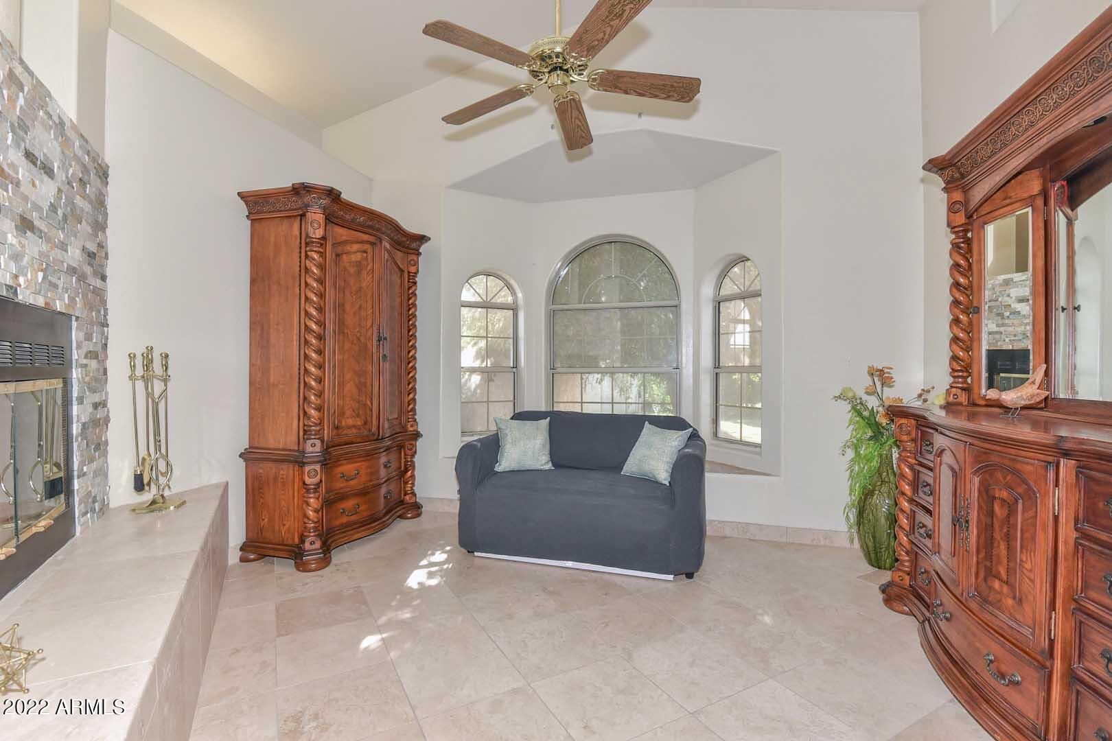 5237 North 106th Avenue Glendale, AZ 85307 - Photo 23 of 75 a living room with furniture and a fireplace