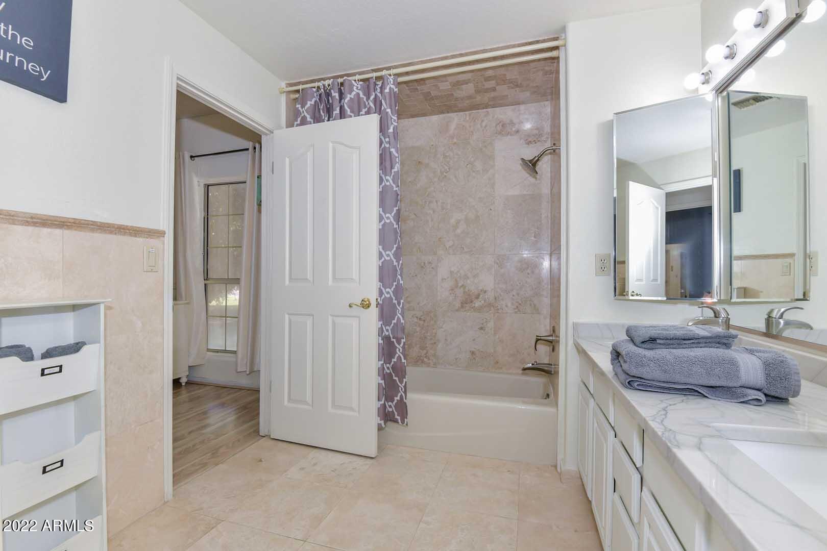 5237 North 106th Avenue Glendale, AZ 85307 - Photo 25 of 75 a spacious bathroom with a granite countertop sink mirror bathtub and shower
