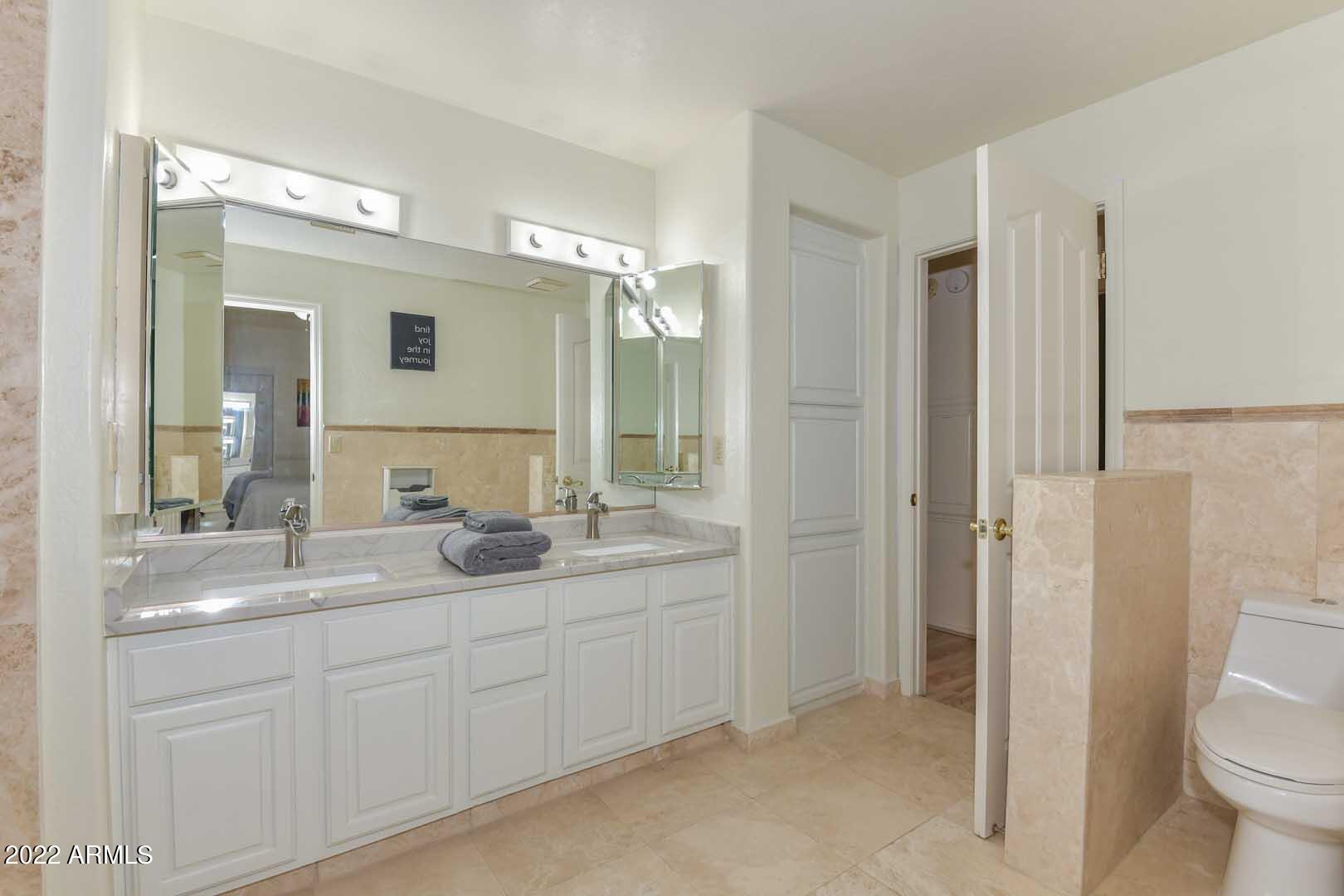 5237 North 106th Avenue Glendale, AZ 85307 - Photo 26 of 75 a bathroom with a granite countertop sink toilet and shower