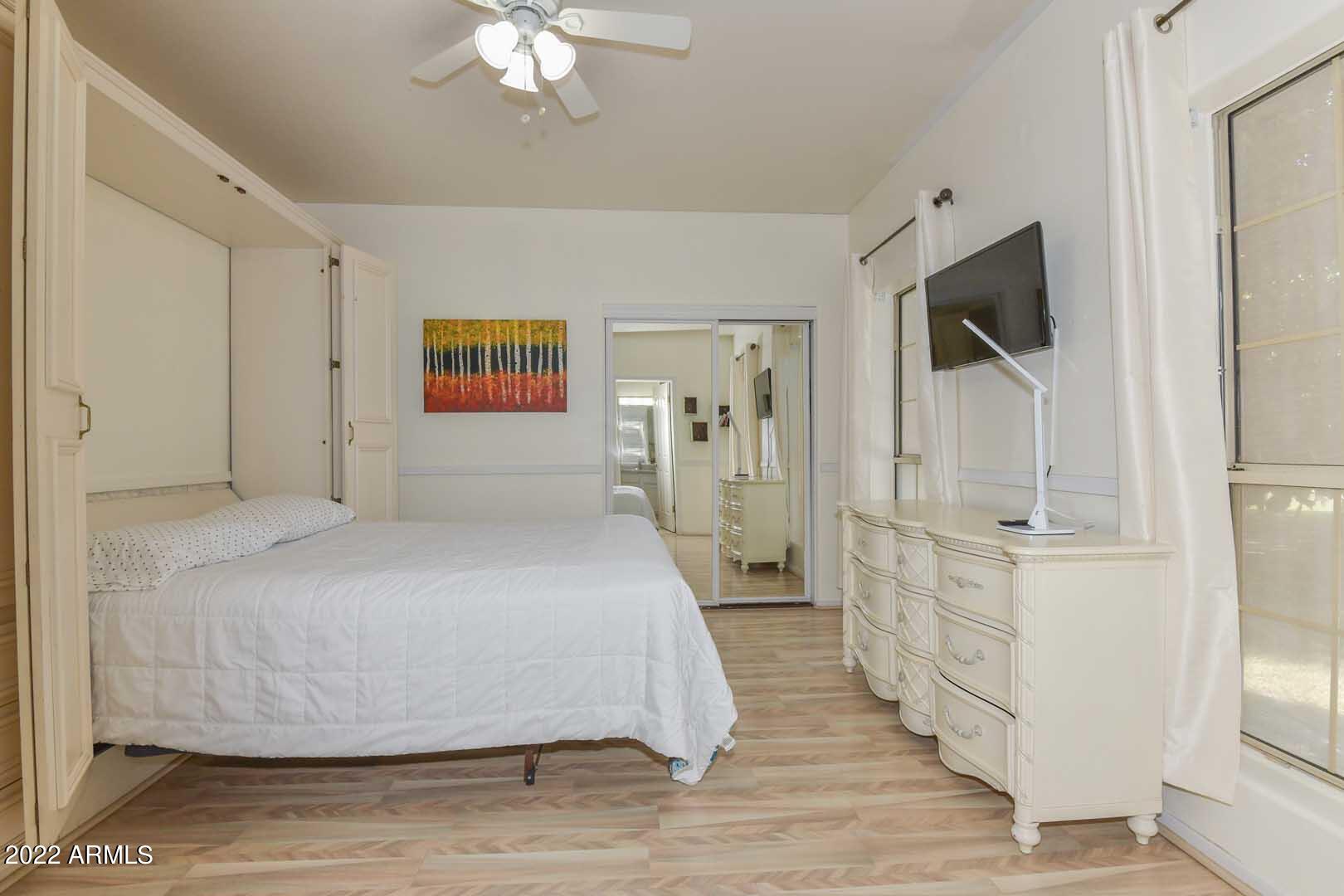 5237 North 106th Avenue Glendale, AZ 85307 - Photo 28 of 75 a spacious bedroom with a bed and a flat screen tv