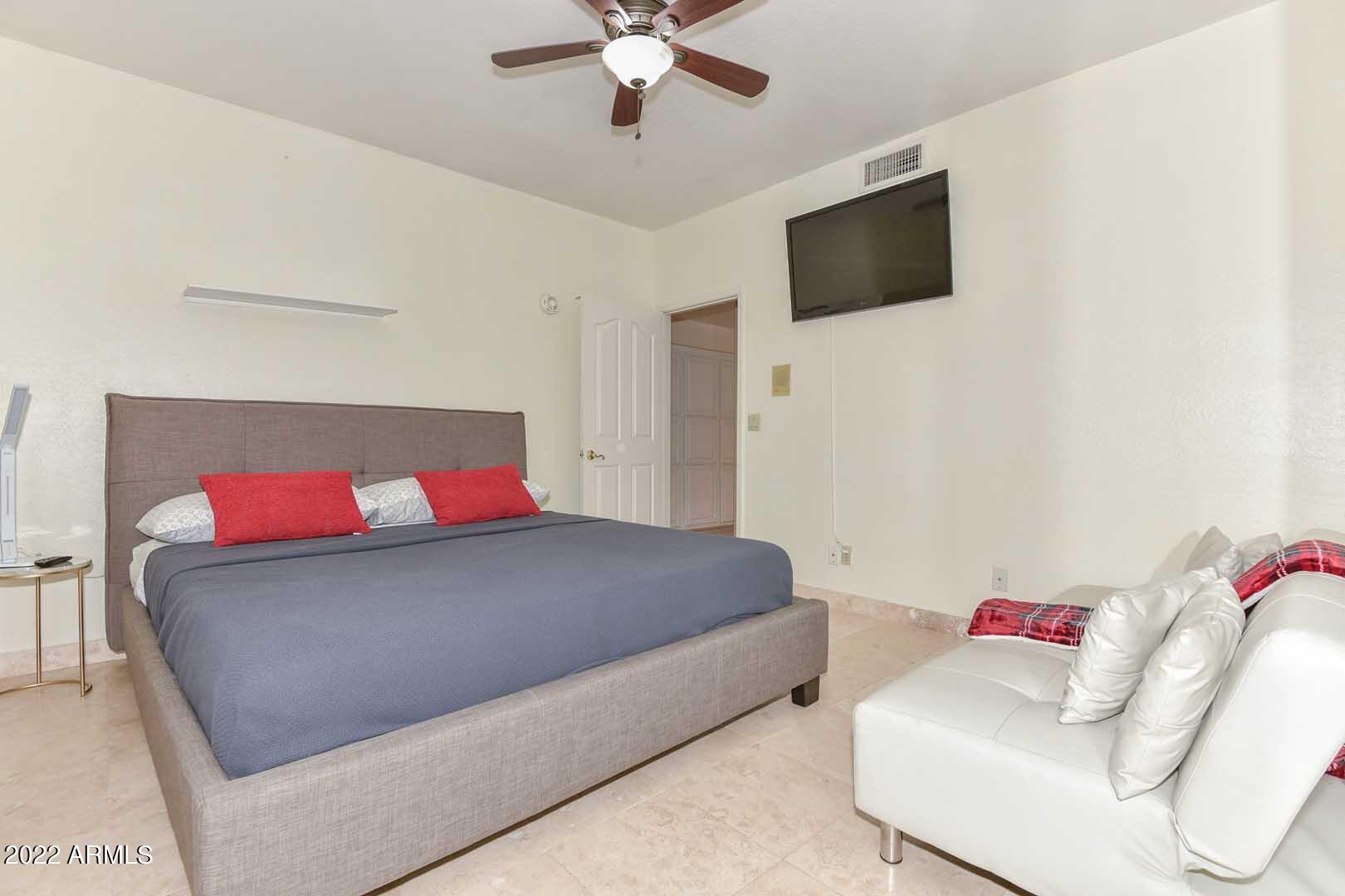 5237 North 106th Avenue Glendale, AZ 85307 - Photo 30 of 75 a living room with a couch and a flat screen tv