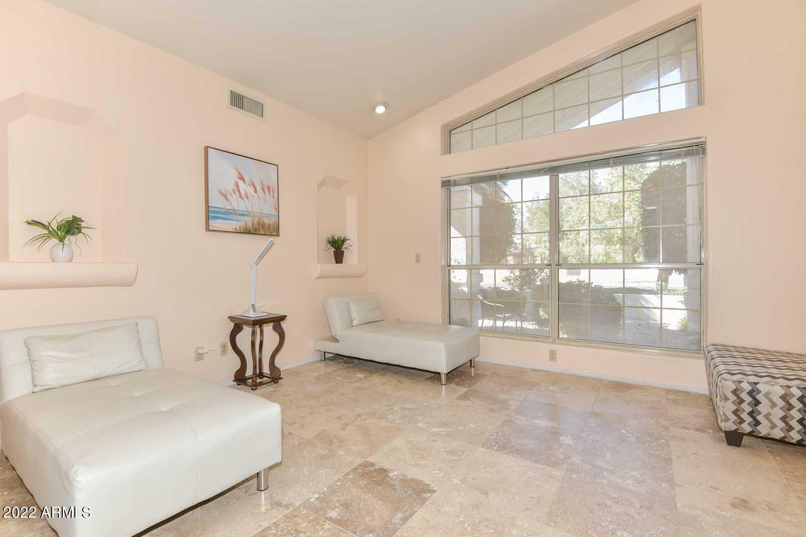 5237 North 106th Avenue Glendale, AZ 85307 - Photo 35 of 75 a spacious bedroom with a bed and a large window
