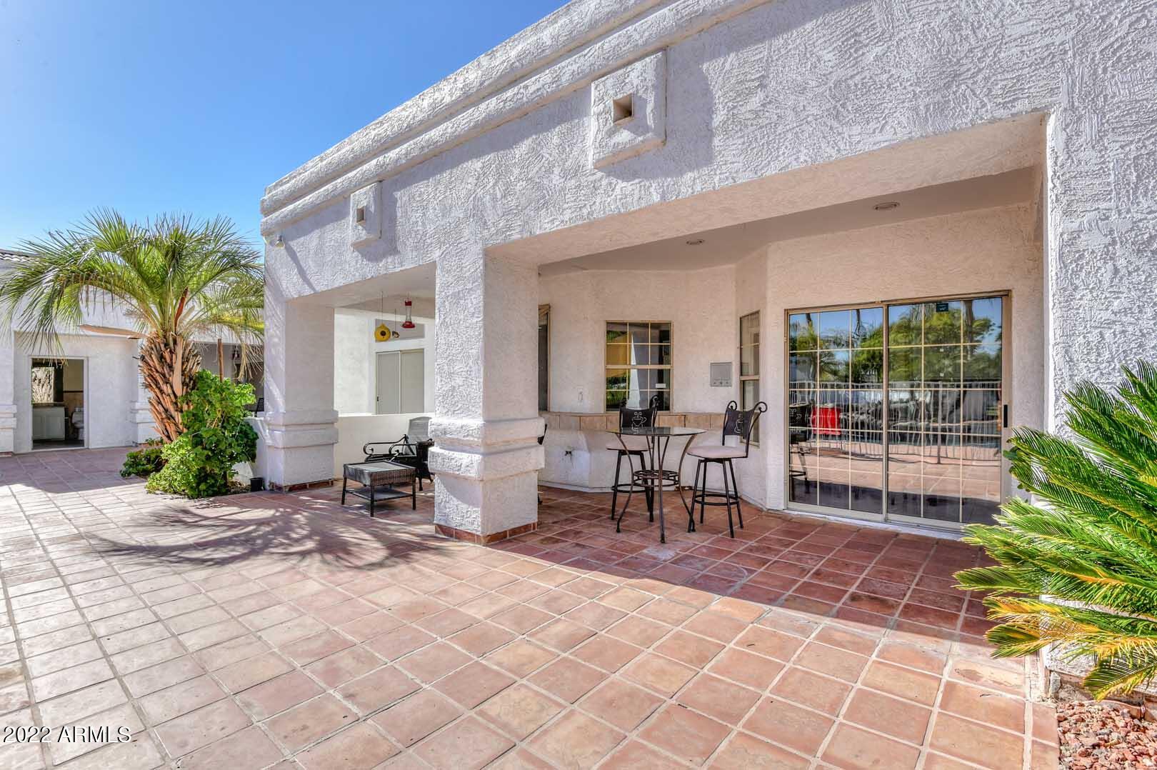 5237 North 106th Avenue Glendale, AZ 85307 - Photo 61 of 75 a view of a patio with table and chairs and potted plants
