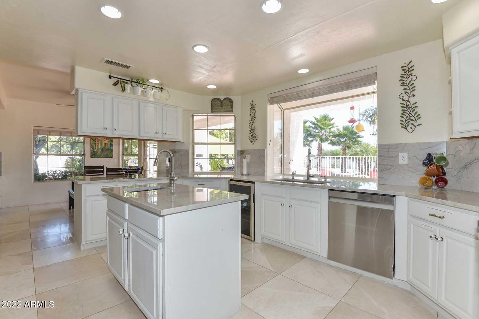 5237 North 106th Avenue Glendale, AZ 85307 - Photo 7 of 75 a kitchen with kitchen island granite countertop appliances cabinets and a sink