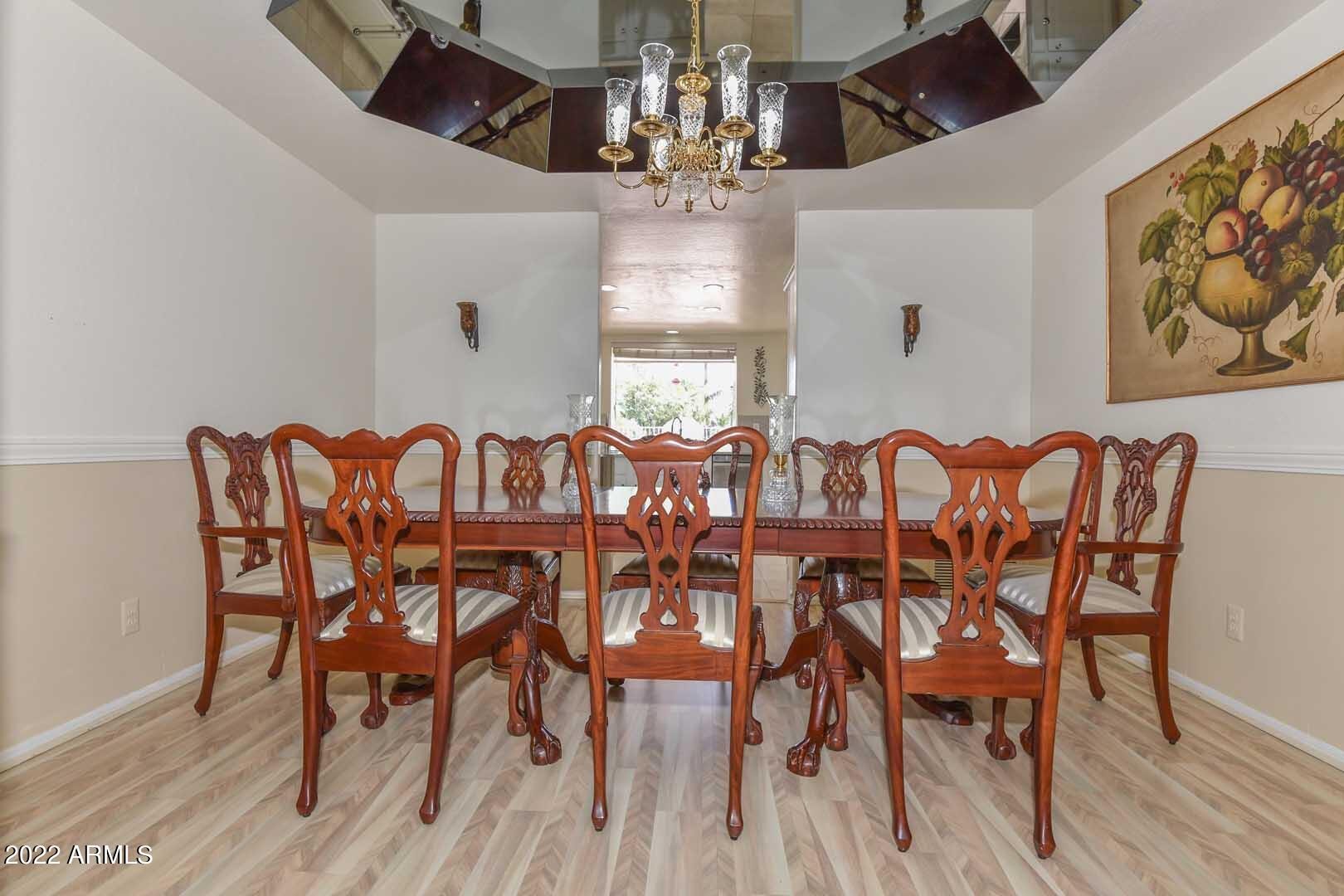 5237 North 106th Avenue Glendale, AZ 85307 - Photo 8 of 75 a view of a dining room with furniture wooden floor and chandelier