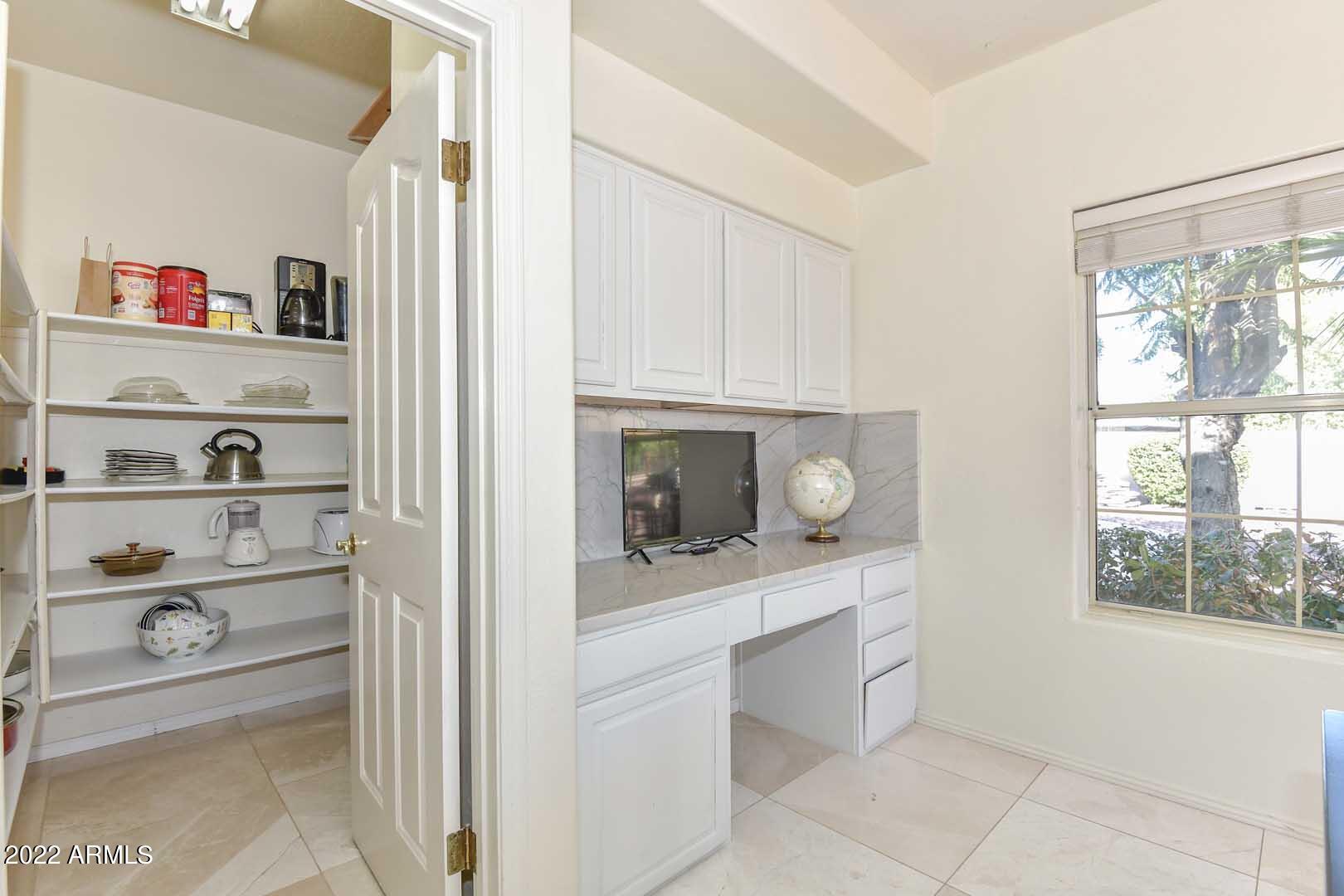 5237 North 106th Avenue Glendale, AZ 85307 - Photo 10 of 75 a kitchen with white cabinets and window