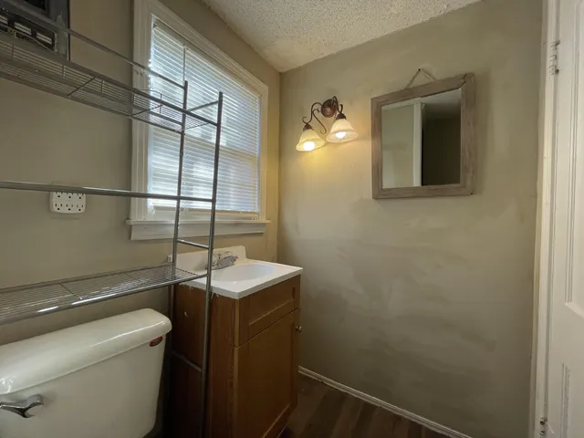 a bathroom with a toilet sink and mirror