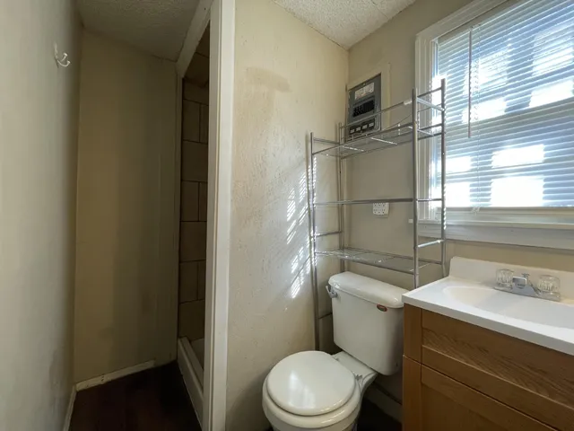 a white toilet sitting next to a bathroom sink