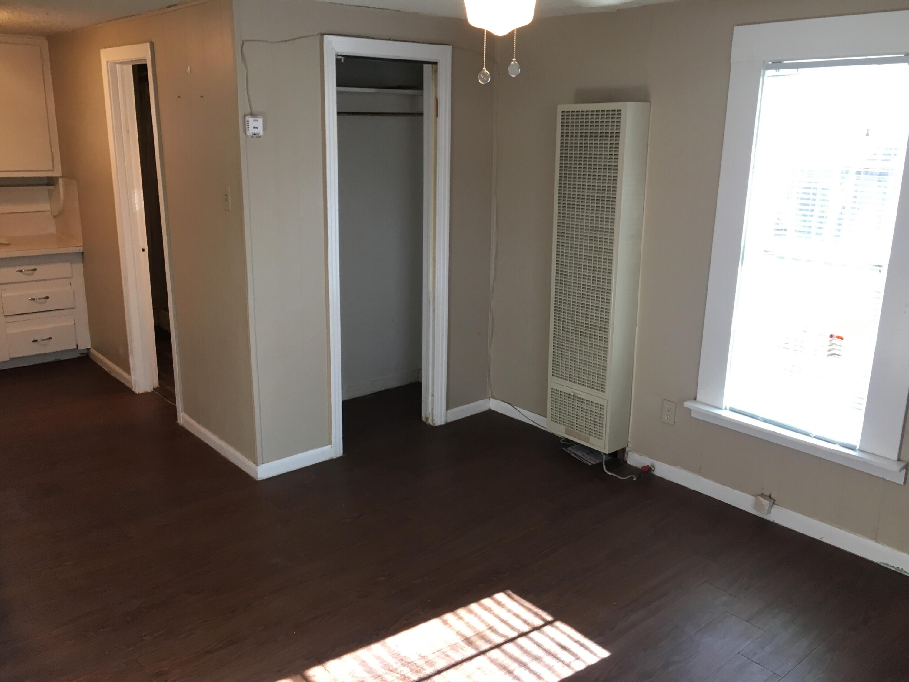 2520 27th Street, Unit REAR HOUSE Lubbock, TX 79410 - Photo 17 of 21 an empty room with wooden floor windows and entrance