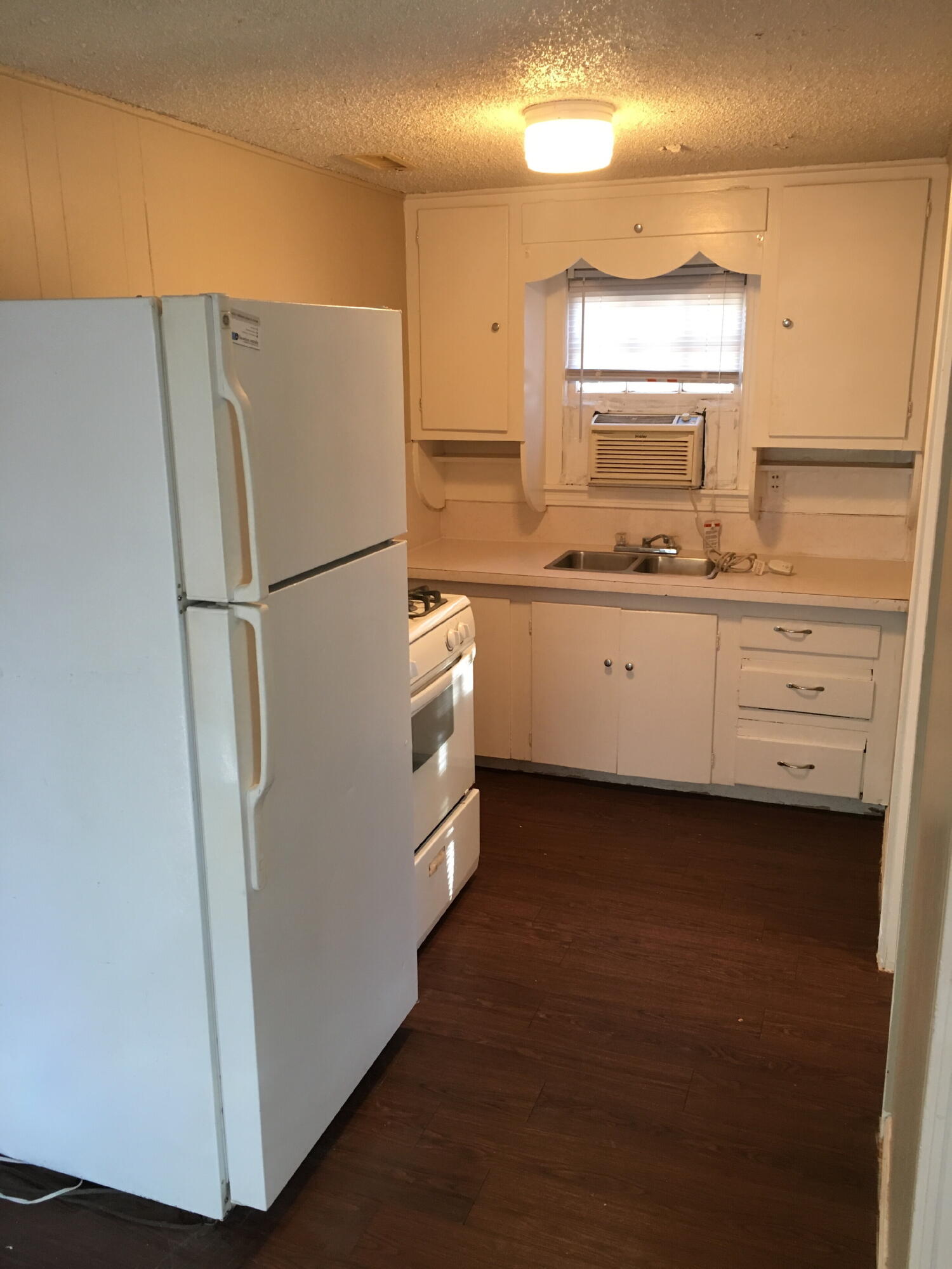 2520 27th Street, Unit REAR HOUSE Lubbock, TX 79410 - Photo 18 of 21 a white refrigerator freezer sitting inside of a kitchen