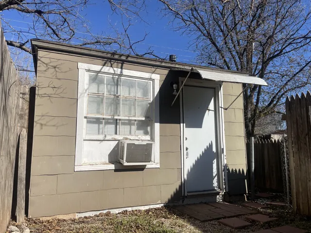 a side view of a house with a porch