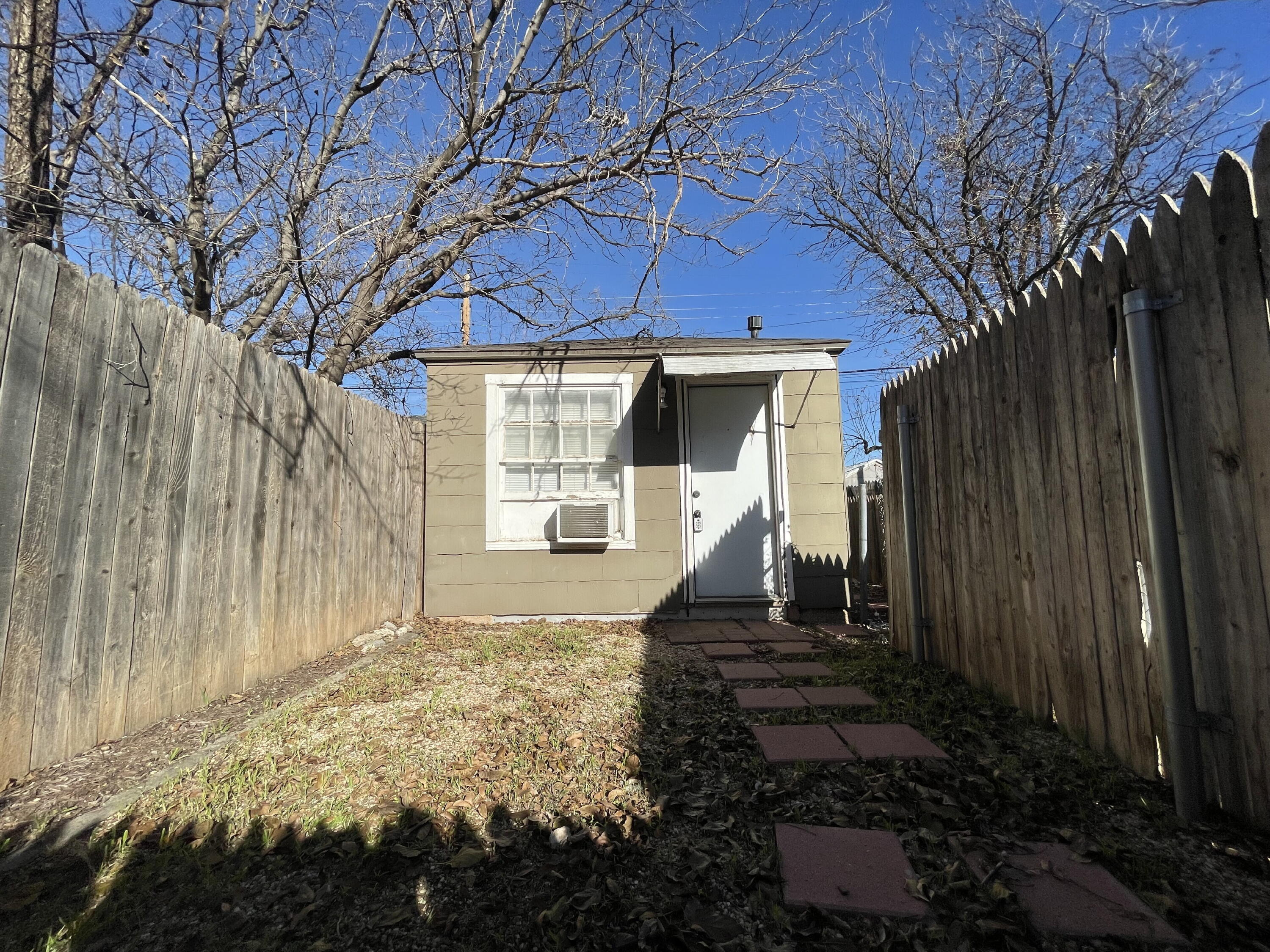 2520 27th Street, Unit REAR HOUSE Lubbock, TX 79410 - Photo 4 of 21 a front view of a house with a yard