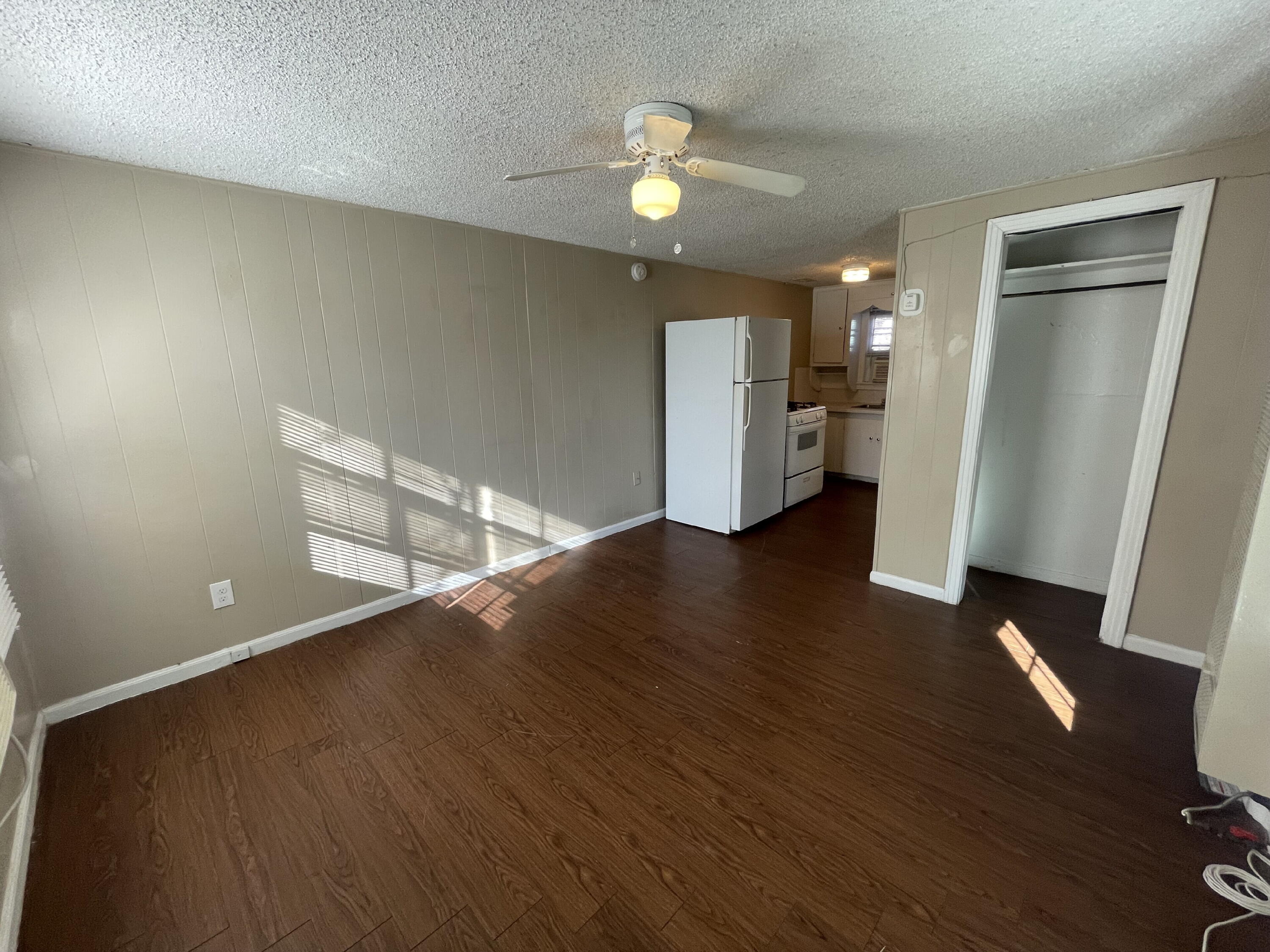 2520 27th Street, Unit REAR HOUSE Lubbock, TX 79410 - Photo 5 of 21 wooden floor in an empty room with a window