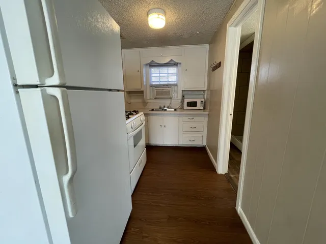 a utility room with cabinets washer and dryer