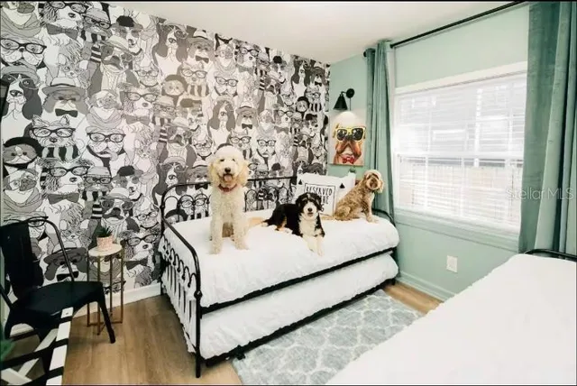 a bedroom with a bed and a window with the shoe rack