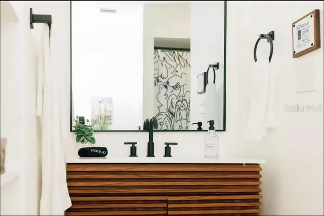 a kitchen with stainless steel appliances kitchen island granite countertop a refrigerator a stove and a sink with granite countertops