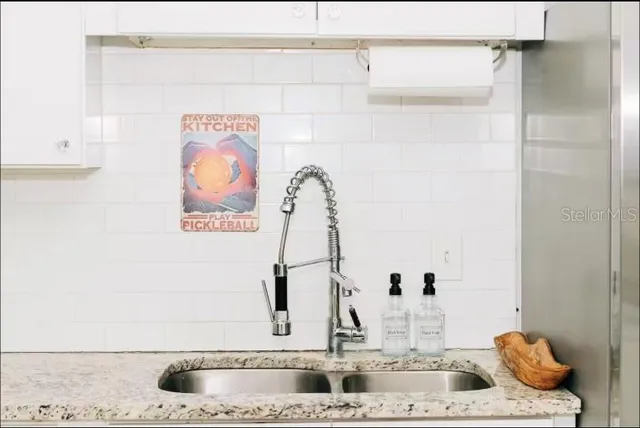 a kitchen with refrigerator and window