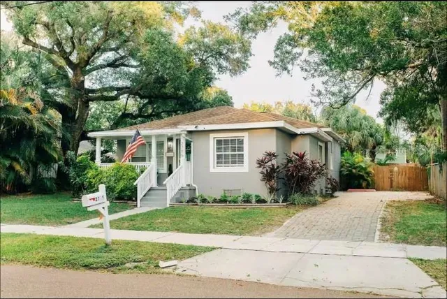 a front view of a house with a garden