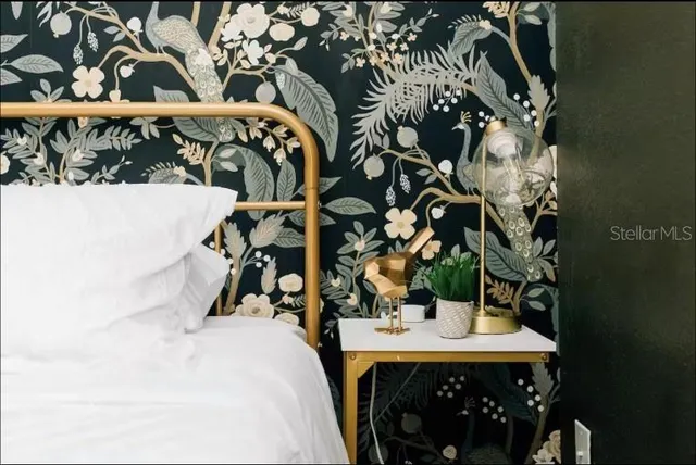 a white bed sitting in a bedroom next to a window