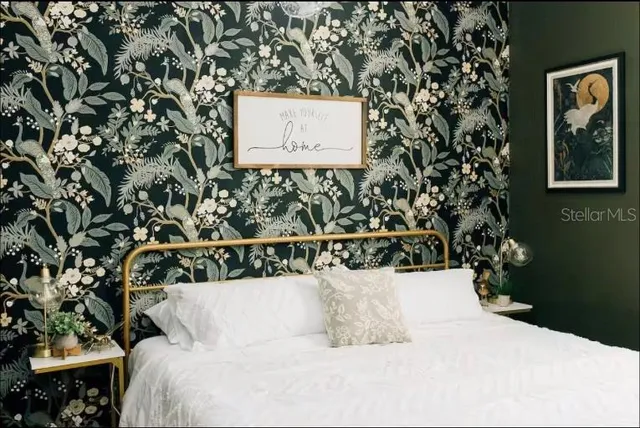 a bedroom with a bed and a chandelier