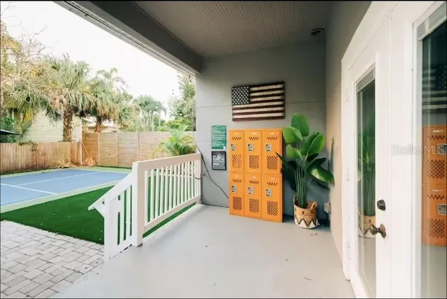 a balcony with furniture and potted plants