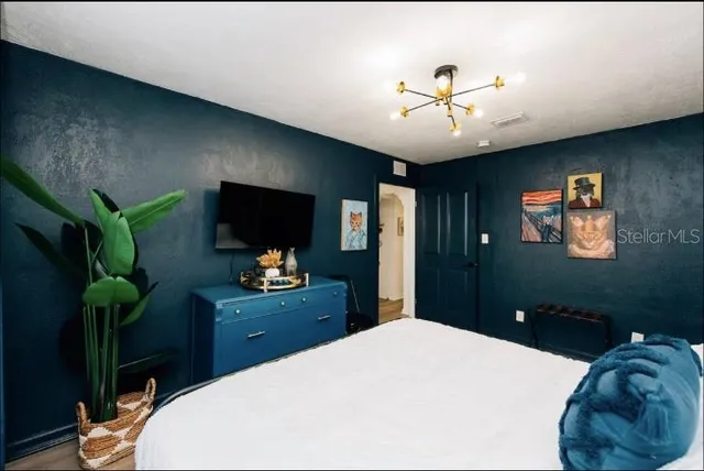 a bedroom with a bed and dresser