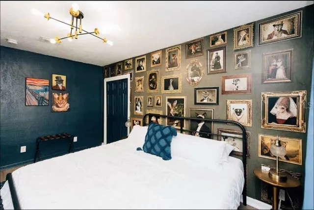 a white bed sitting in a bedroom next to a window