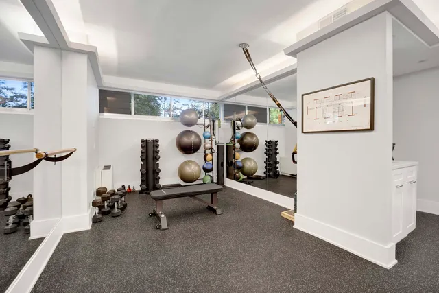 a room with gym equipment and view of living room