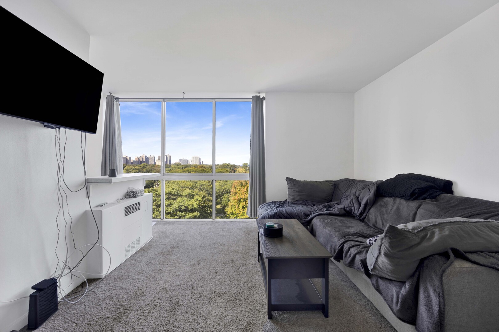 1555 North Dearborn Parkway, Unit 8C Chicago, IL 60610 - Photo 6 of 20 a living room with furniture a flat screen tv and a refrigerator