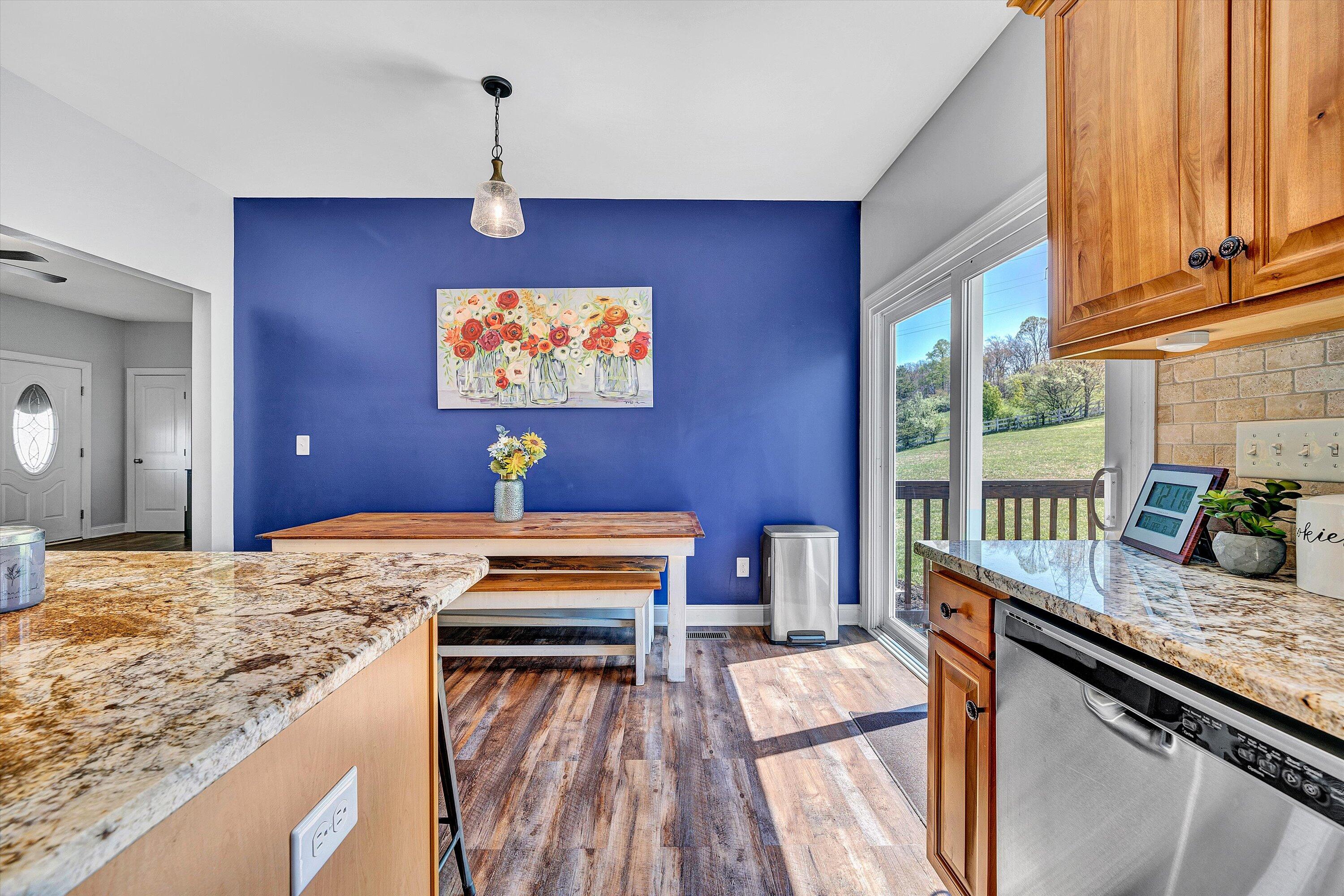 8350 Newport Road Catawba, VA 24070 - Photo 11 of 75 a view of a kitchen with kitchen island granite countertop wooden floor and a counter top space