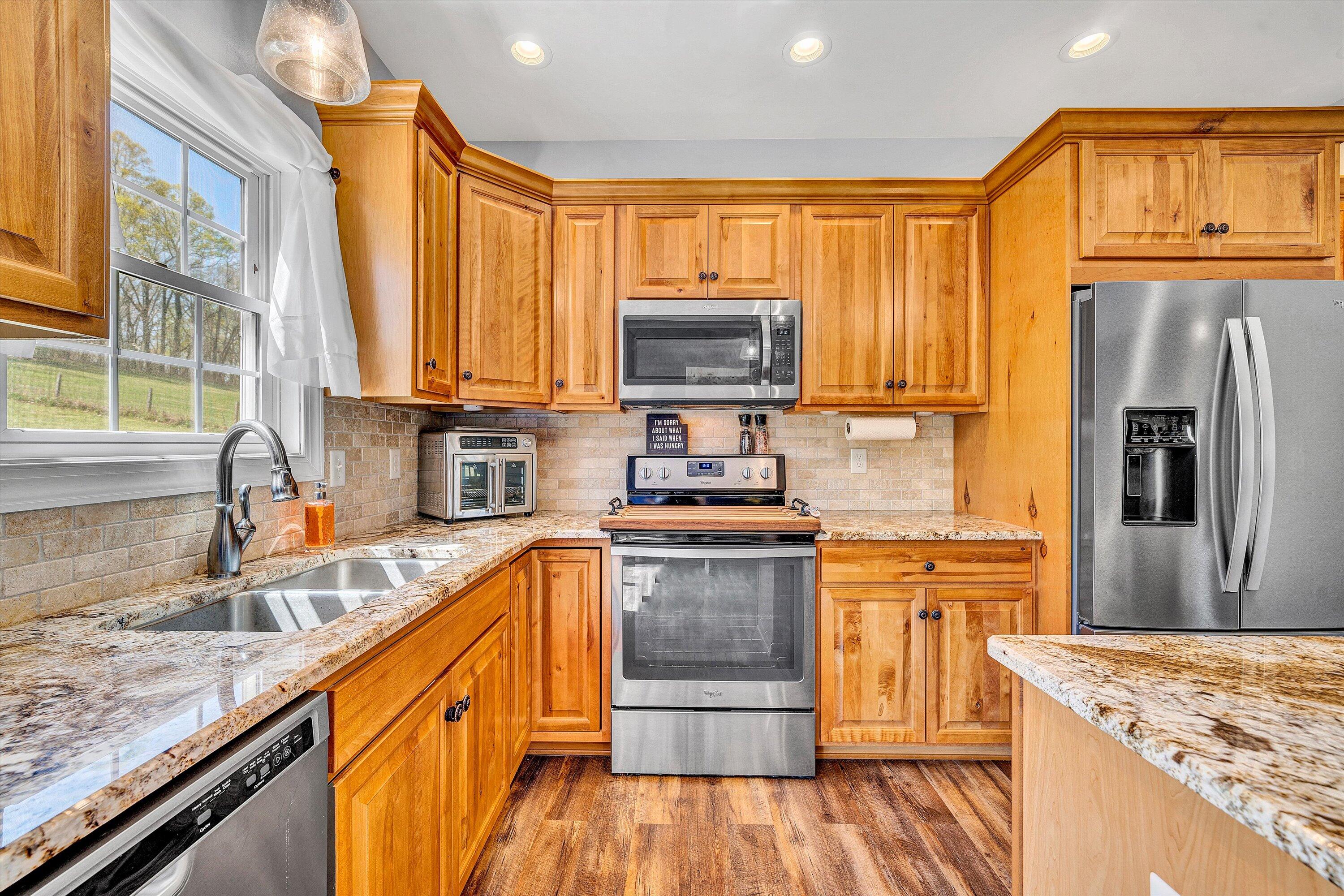 8350 Newport Road Catawba, VA 24070 - Photo 16 of 75 a kitchen with stainless steel appliances granite countertop a stove a sink and a microwave