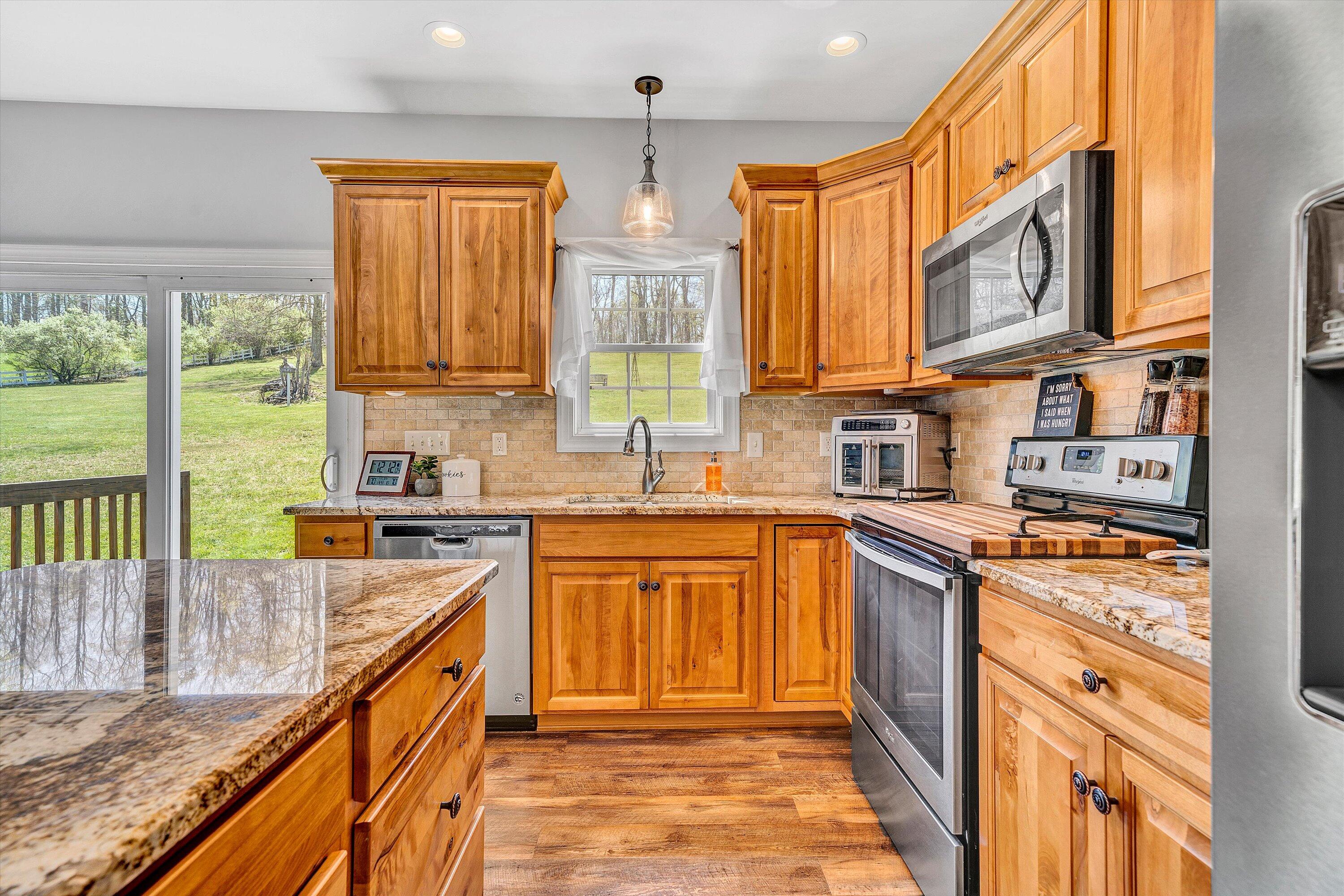 8350 Newport Road Catawba, VA 24070 - Photo 18 of 75 a kitchen with stainless steel appliances granite countertop a stove a sink and a microwave