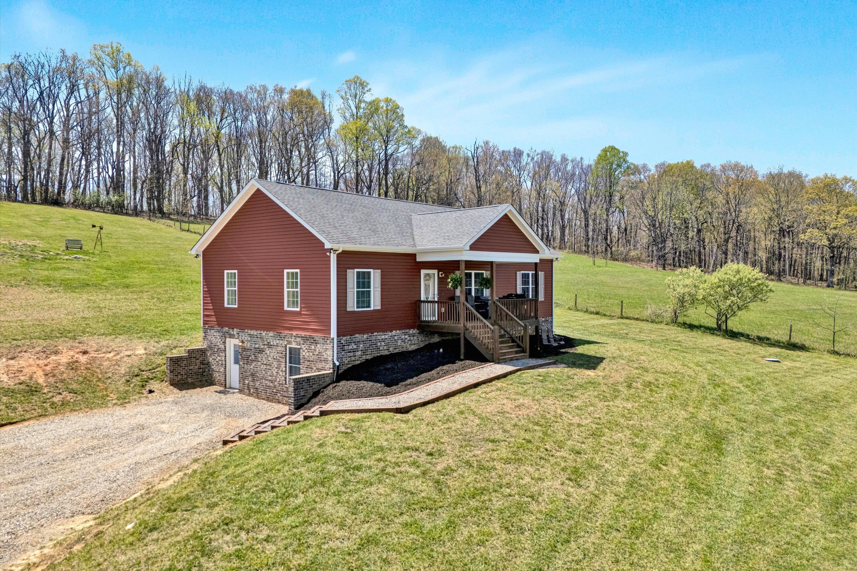 8350 Newport Road Catawba, VA 24070 - Photo 2 of 75 a front view of a house with a yard and garage