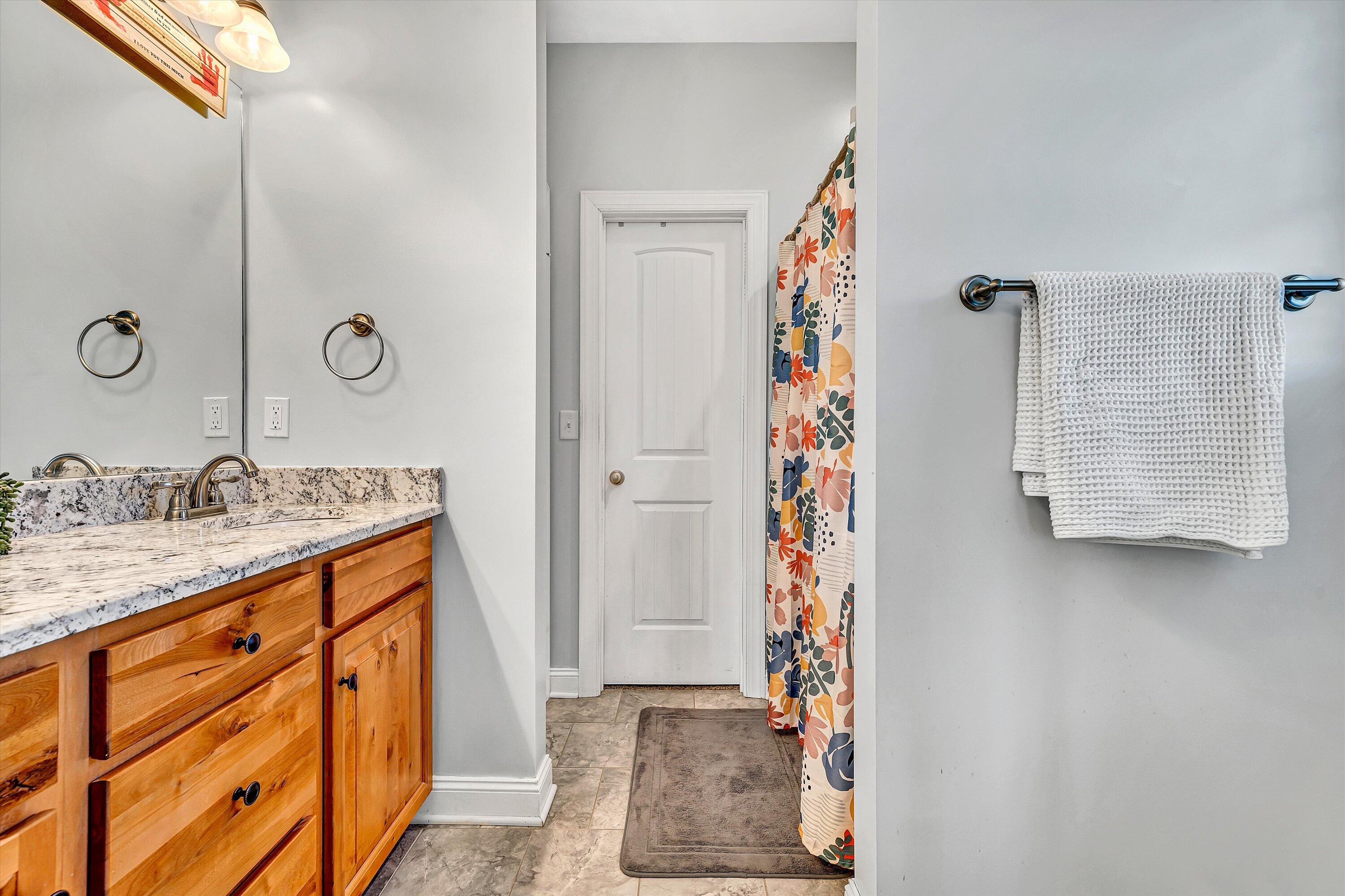 8350 Newport Road Catawba, VA 24070 - Photo 22 of 75 a bathroom with a granite countertop sink and a mirror