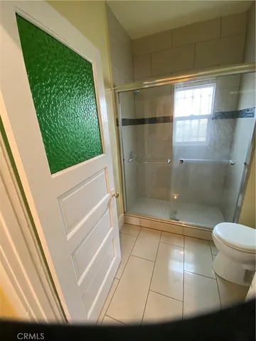 a bathroom with a shower and a toilet