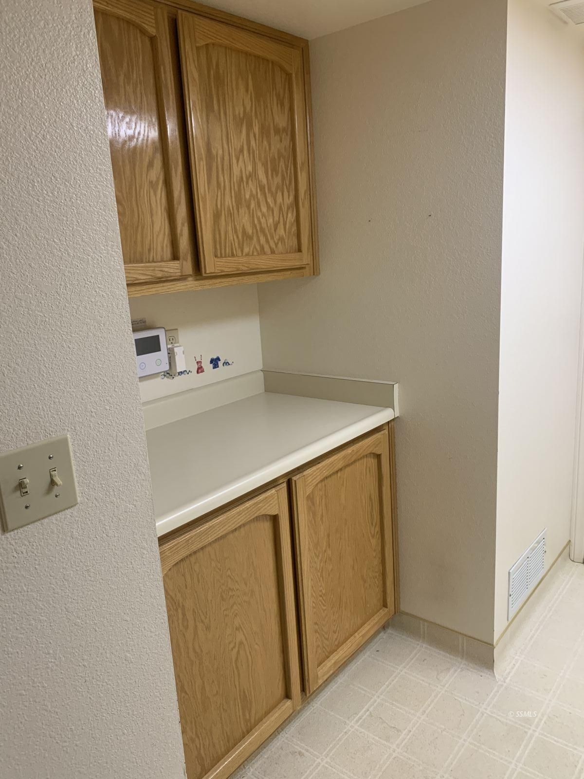 328 Ashton Street Ridgecrest, CA 93555 - Photo 10 of 28 a utility room with a sink a vanity and a wooden floor