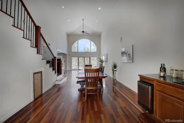 a view of a dining room with furniture a chandelier and wooden floor