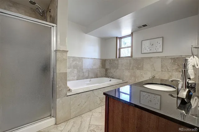 a bathroom with a sink a toilet and a shower