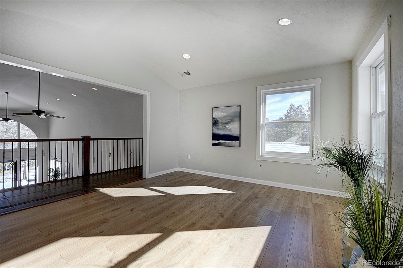 27987 Pine Grove Trail Conifer, CO 80433 - Photo 22 of 37 a view of an empty room with wooden floor and a window