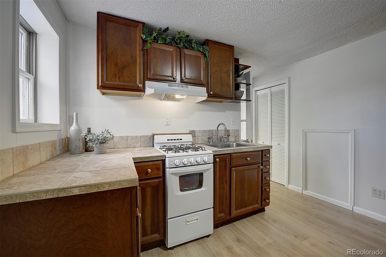 27987 Pine Grove Trail Conifer, CO 80433 - Photo 27 of 37 a kitchen with stainless steel appliances granite countertop wooden cabinets stove top oven and sink